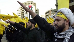 Hezbollah fighters take an oath to continue the path of resistance against Israel during a parade in 2000. (photo credit: AP/Hussein Malla)