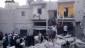 In this Monday, March 18, 2013, citizen journalism image provided by Aleppo Media Center AMC which has been authenticated based on its contents and other AP reporting, Syrian citizens stand on rubble of houses that were destroyed due to Syrian forces airstrikes, at al-Marjeh neighborhood, in Aleppo, Syria (photo credit: AP/Aleppo Media Center)