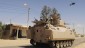 Egyptian Army soldiers patrol in an armored vehicle backed by a helicopter gunship during a sweep through villages in Sheik Zweid, northern Sinai, Egypt, Tuesday, May 21, 2013. (photo credit: AP)