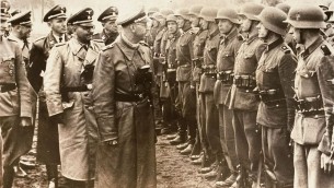 The June 3, 1944 photo provided by the US Holocaust Memorial Museum shows Heinrich Himmler, centre, SS Reichsfuehrer-SS, head of the Gestapo and the Waffen-SS, and Minister of the Interior of Nazi Germany from 1943 to 1945, as he reviews troops of the Galician SS-Volunteer Infantry Division. Michael Karkoc a top commander whose Nazi SS-led unit is blamed for burning villages filled with women and children lied to American immigration officials to get into the United States and has been living in Minnesota since shortly after World War II, according to evidence uncovered by The Associated Press. (photo credit: AP/ US Holocaust Memorial Museum, courtesy of Atlantic Foto Verlag Berlin)