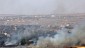 Smoke rises from a fire as a result of fighting in the Syrian village of Quneitra near the border with Israel, as seen from an observatory near the Quneitra crossing, Thursday, June 6, 2013. Syrian rebels on Thursday captured a crossing point along a cease-fire line with Israel in the contested Golan Heights, a development that could deepen Israeli concerns over the growing role of Islamic radicals in the civil war near its northern frontier.(AP Photo/Sebastian Scheiner)