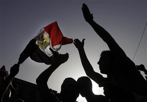 Egyptian protesters shout anti-Muslim brotherhood slogans and wave a national flag during a protest against the new judiciary law at the high court in Cairo, Egypt, Monday, June 3, 2013.(photo credit: AP Photo/Amr Nabil)