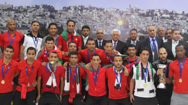 The Palestinian national soccer team along with PA President Mahmoud Abbas after winning the AFC Challenge Cup in late May 2014 (photo credit: Issam Rimawi/ Flash 90)