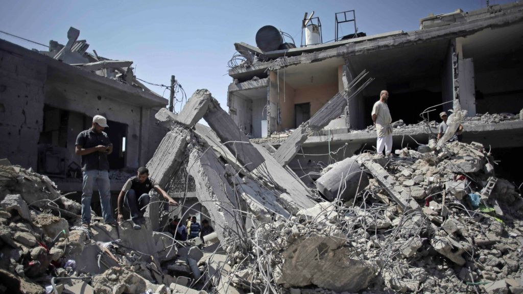 Palestinians search in the rubble of a destroyed house where eight members of the Al Haj family were killed in a strike early morning in Khan Younis refugee camp, southern Gaza Strip on Thursday, July 10, 2014. (AP Photo/Khalil Hamra) Palestinians search in the rubble of a destroyed house where eight members of the Al Haj family were killed in a strike early morning in Khan Younis refugee camp, southern Gaza Strip on Thursday, July 10, 2014. (AP Photo/Khalil Hamra)