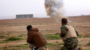 Kurdish peshmerga fighters detonate a landmine planted by the Islamic State (IS) group fighters on the outskirts of the village of Sinuni in the northern Iraqi district of Sinjar on January 15, 2015, after it was recaptured by Kurdish peshmerga troops. (photo credit: AFP/SAFIN HAMED)