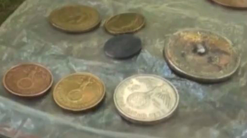 German coins, dating to the Nazi era, discovered at a remote location in Argentina believed to have been built as a hideout for Nazi war criminals. (screen capture: YouTube/AllNews)