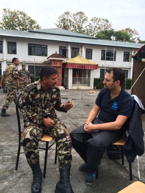 Yotam Polizer, IsraAID's Head of Mission and IsraAID Asia Director, speaks with a Nepalese army official, in a picture released by IsraAID on Tuesday, April 28, 2015. (Photo credit: Courtesy IsraAID) Yotam Polizer, IsraAID's Head of Mission and IsraAID Asia Director, speaks with a Nepalese army official, in a picture released by IsraAID on Tuesday, April 28, 2015. (Photo credit: Courtesy IsraAID)