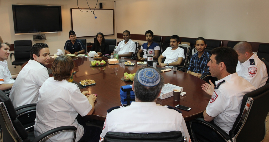 Nepalese students having a discussion with Magen David Adom paramedics and organization head Eli Bin after receiving diplomas of recognition from the organization. (Photo credit: Magen David Adom) Nepalese students having a discussion with Magen David Adom paramedics and organization head Eli Bin after receiving diplomas of recognition from the organization. (Photo credit: Magen David Adom)