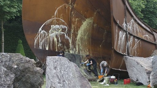 Chateau de Versailles workers clean the sculpture 'Dirty Corners' by British artist Anish Kapoor, after someone splattered paint on it in the gardens of the Chateau de Versailles outside Paris, France, Thursday, June 18, 2015. The sculpture is nicknamed 'The Queen's Vagina' (AP Photo/Michel Euler) Chateau de Versailles workers clean the sculpture 'Dirty Corners' by British artist Anish Kapoor, after someone splattered paint on it in the gardens of the Chateau de Versailles outside Paris, France, Thursday, June 18, 2015. The sculpture is nicknamed 'The Queen's Vagina' (AP Photo/Michel Euler)