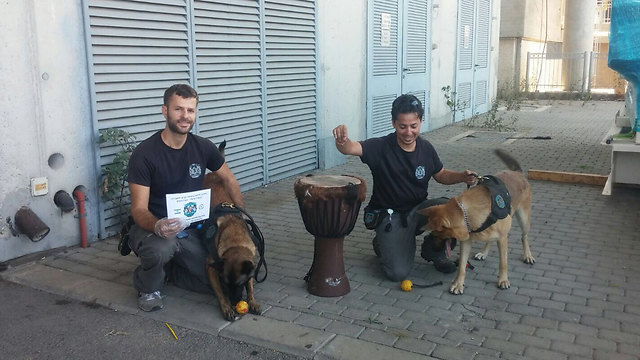 Customs investigators and a drug-sniffing dog pose next to the hashish-lined drum. (Courtesy Ben Gurion Customs) Customs investigators and a drug-sniffing dog pose next to the hashish-lined drum. (Courtesy Ben Gurion Customs)