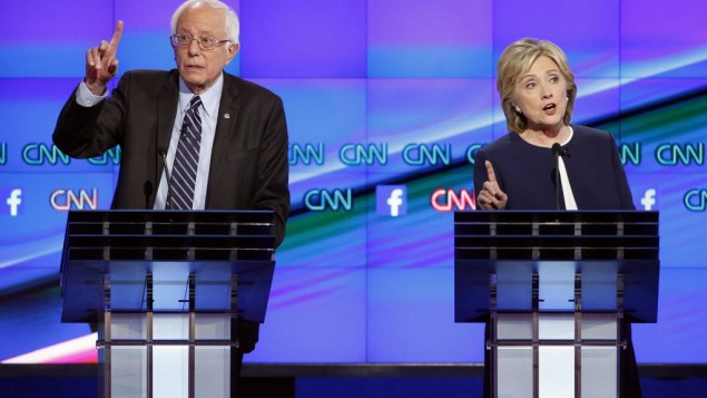 Sen. Bernie Sanders, of Vermont, left, speaks as Hillary Rodham Clinton looks on during the CNN Democratic presidential debate Tuesday, Oct. 13, 2015. (Photo by AP Photo/John Locher)