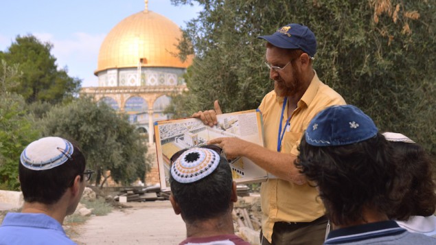 On a tour of the Temple Mount, Yehuda Glick shows religious Jews a diagram of the Jewish Temple, which once stood where the golden Dome of the Rock stands today, September 17, 2013, in Jerusalem Israel. (Christa Case Bryant/The Christian Science Monitor via Getty Images)