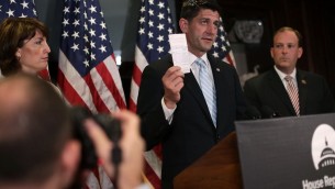 US Speaker of the House Paul Ryan holds up a copy of the US Constitution during a press briefing on July 6, 2016. (Alex Wong/Getty Images/AFP)