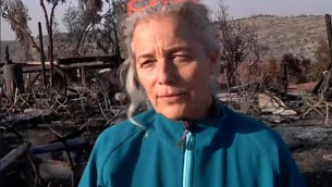 Rama Ben Zvi walking amid the smoldering embers of her burned down restaurant, on Saturday, November 26 2016. (Screen capture Channel 2) Rama Ben Zvi walking amid the smoldering embers of her burned down restaurant, on Saturday, November 26 2016. (Screen capture Channel 2)