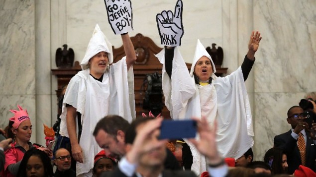 Protesters wearing white sheets shout at Sen. Jeff Sessions (R-AL) as he arrives for his confirmation hearing to be the US attorney general on 10, 2017 in Washington, DC. (Somodevilla/Getty Images/AFP)