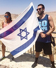 Myles Field and his sister, Dayna, wave an Israeli flag during a visit there.
